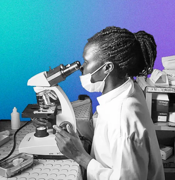 Scientist looking down a microscope