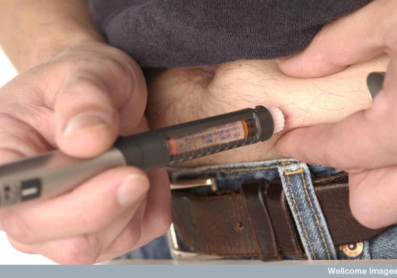 A diabetic injects himself using an insulin pen
